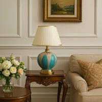 Gold LED picture light illuminates framed art in modern living room setting creating warm focused wall display lighting.