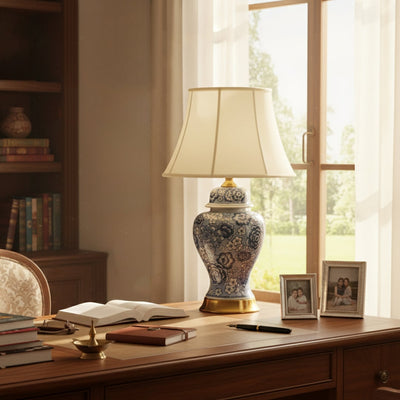 Beautiful floral ceramic table lamp with intricate blue design and gold detailing enhances study table decor with artistic craftsmanship.