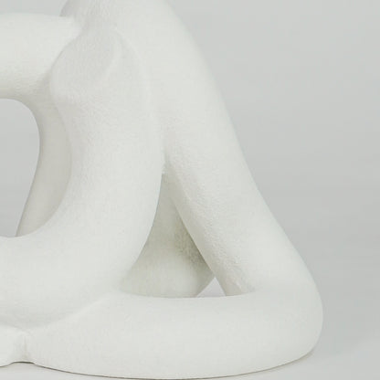 Closeup image of white ceramic abstract loop sculpture for modern tabletop decor styling with elegant matte finish.