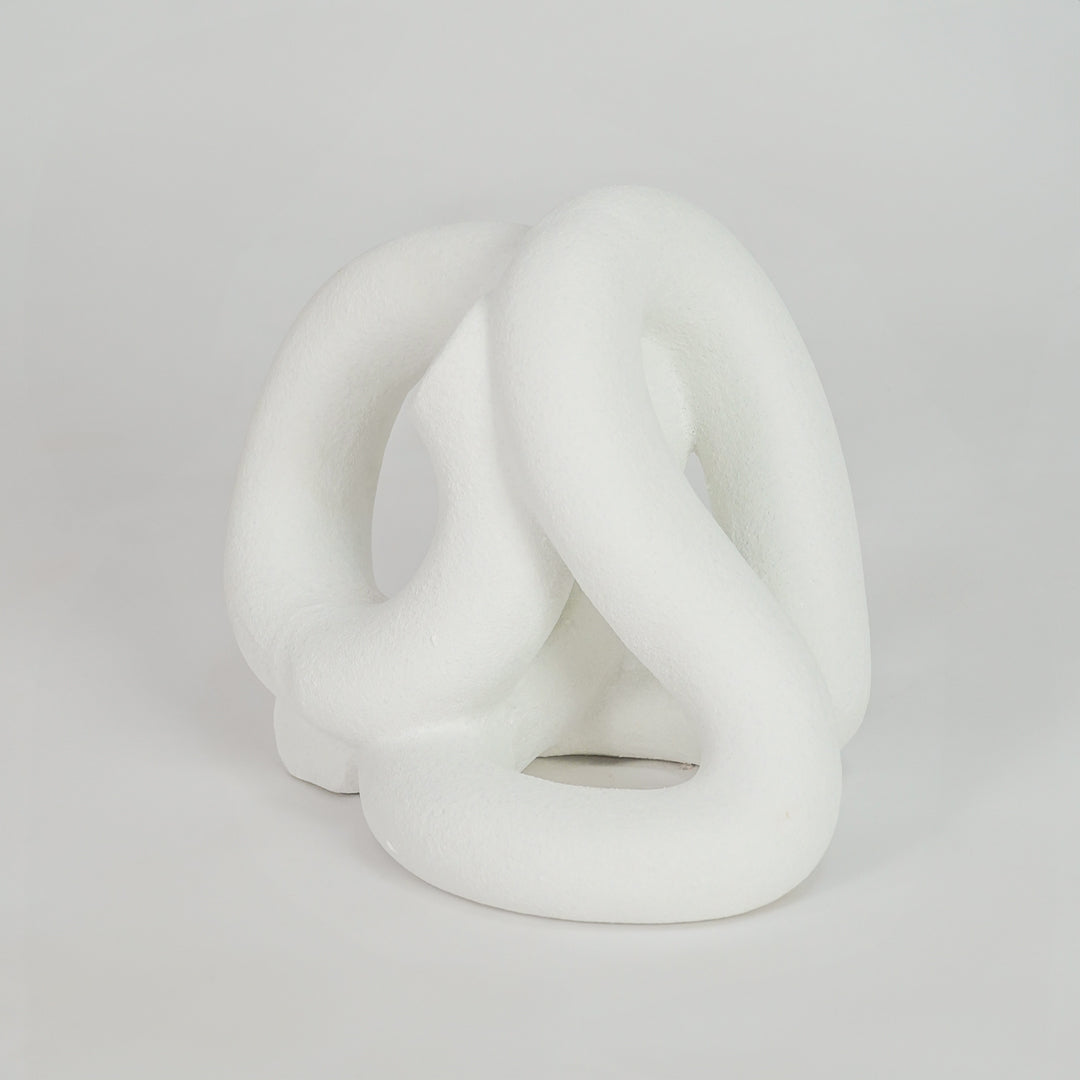 White abstract ceramic decorative sculpture on white background for stylish contemporary home decor.