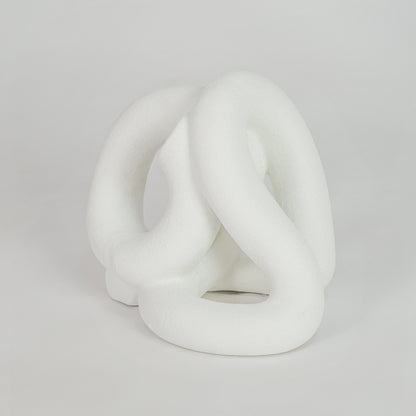 White abstract ceramic decorative sculpture on white background for stylish contemporary home decor.