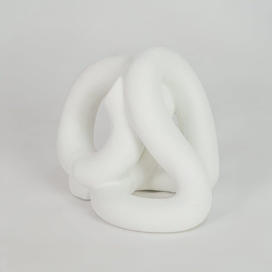 White abstract ceramic decorative sculpture on white background for stylish contemporary home decor.