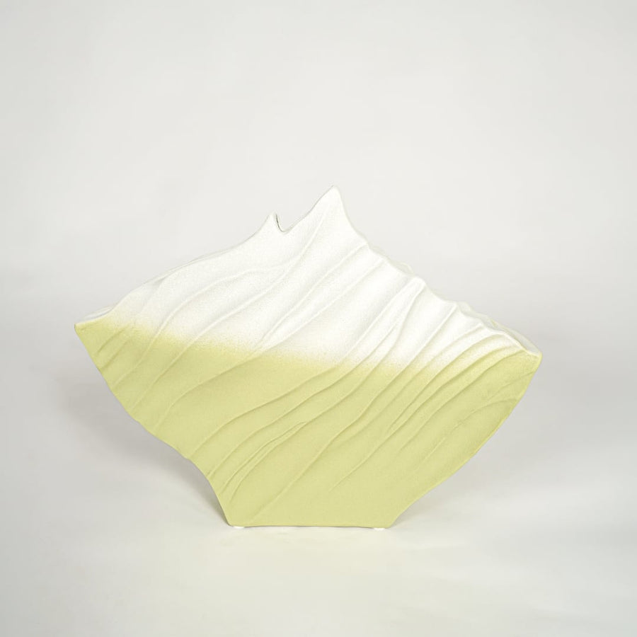 White and green decorative ceramic vase on white background modern home decor accent piece for console table styling.
