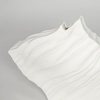 Textured white ceramic abstract vase closeup modern decorative vase for shelf console table living room decor styling.