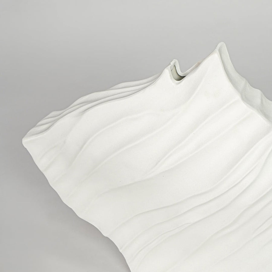 Textured white ceramic abstract vase closeup modern decorative vase for shelf console table living room decor styling.