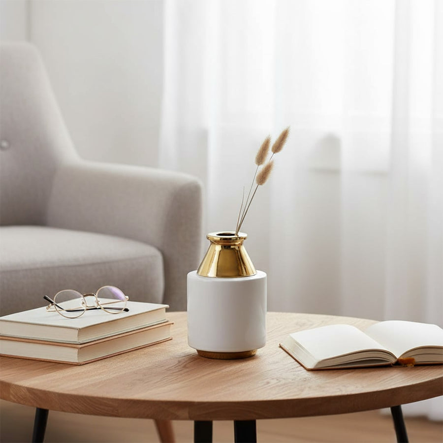 White and gold modern ceramic vase styled on a marble surface ideal for elegant home decor accents and premium interior styling.