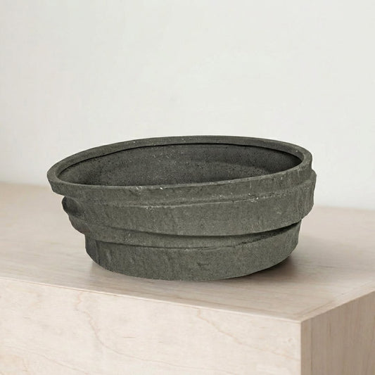 Black ceramic decorative serving bowl with textured stone finish perfect for fruit display on dining table centerpiece and modern home decor.