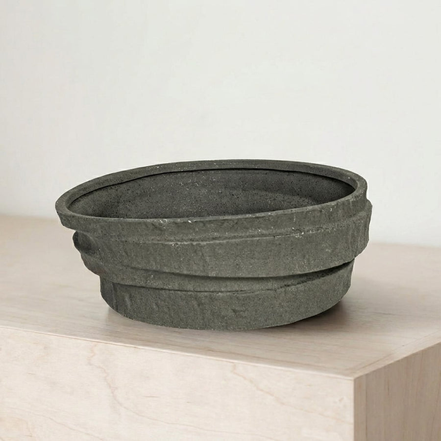 Black ceramic decorative serving bowl with textured stone finish perfect for fruit display on dining table centerpiece and modern home decor.