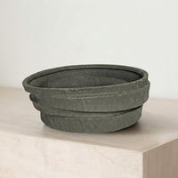 Black ceramic decorative serving bowl with textured stone finish perfect for fruit display on dining table centerpiece and modern home decor.
