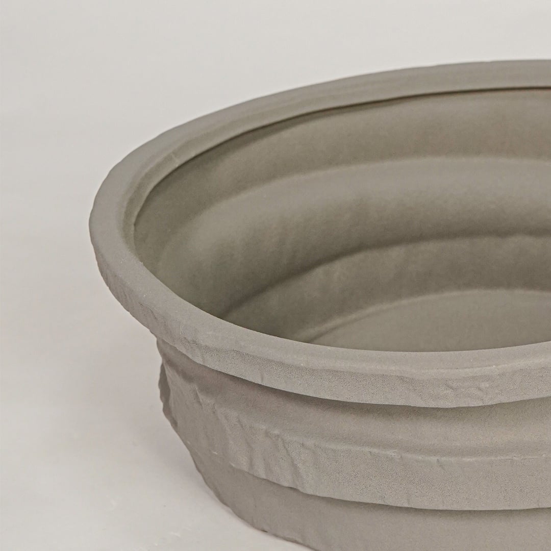 Closeup of grey ceramic decorative bowl with layered textured finish for elegant tabletop decor styling ideas.