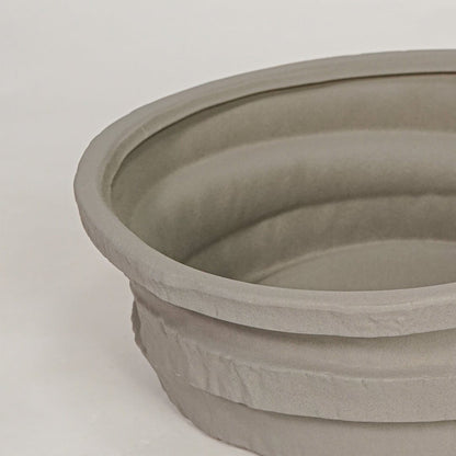 Closeup of grey ceramic decorative bowl with layered textured finish for elegant tabletop decor styling ideas.