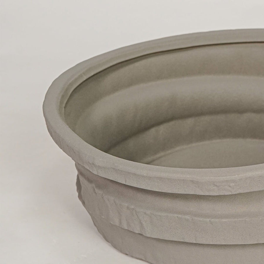 Closeup of grey ceramic decorative bowl with layered textured finish for elegant tabletop decor styling ideas.