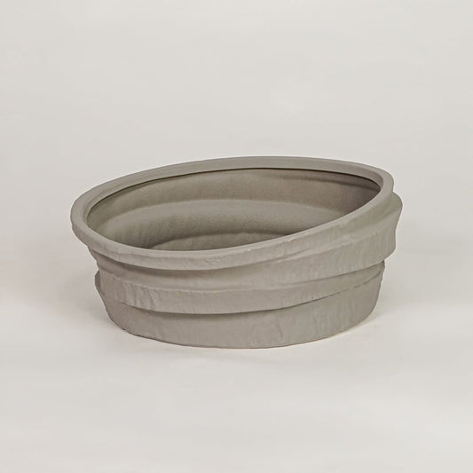 Grey ceramic decorative bowl with layered textured design for modern tabletop shelf and console decor placement.
