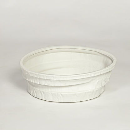 White ceramic round decorative tray with textured rim and smooth interior isolated on clean white background for modern decor styling.