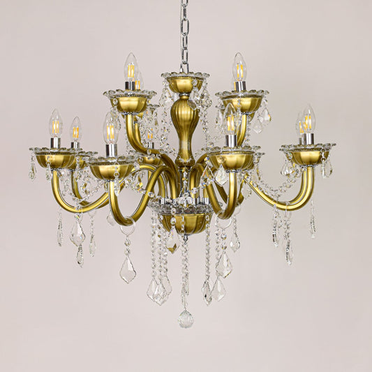 Gold metal chandelier with ornate arms and crystal drops shown on a white background for elegant home decor inspiration.