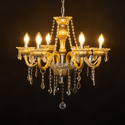 Vintage gold metal crystal chandelier glowing warmly on black background creating a dramatic elegant ceiling feature.