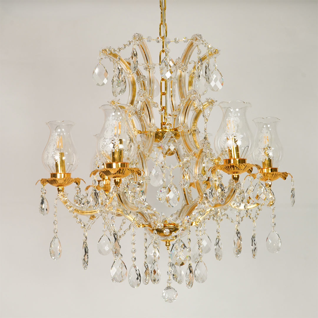 White background image of antique style clear glass chandelier for elegant dining room decor styling with unlit glass arms.
