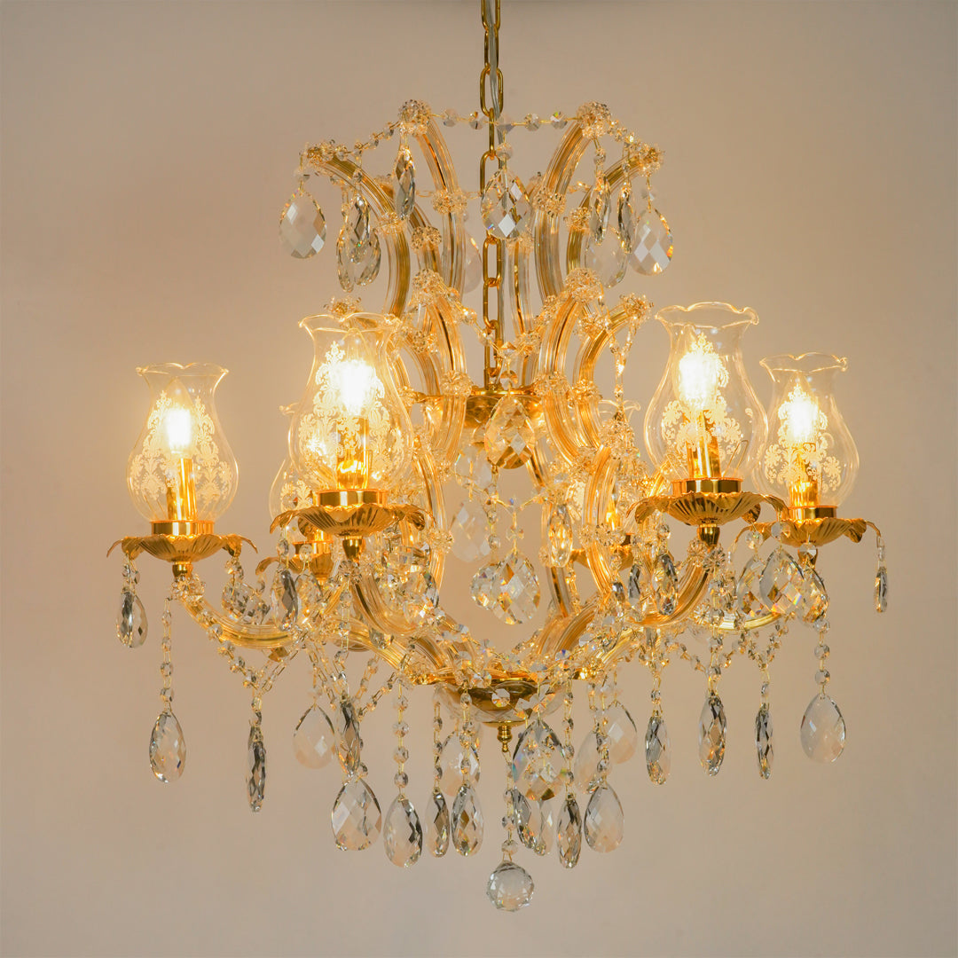 White background image of antique style clear glass chandelier for modern living room decor styling with bright lighting.
