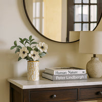 Stylish ceramic jar with golden botanical pattern and wooden lid displayed in a bright minimal setting  adding a refined decorative touch.