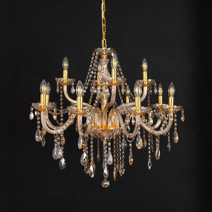 Golden chandelier with crystal droplets displayed off on black background for elegant decorative lighting style.