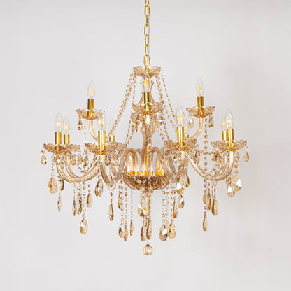 Golden chandelier with crystal droplets displayed off on white background for modern home interior lighting.