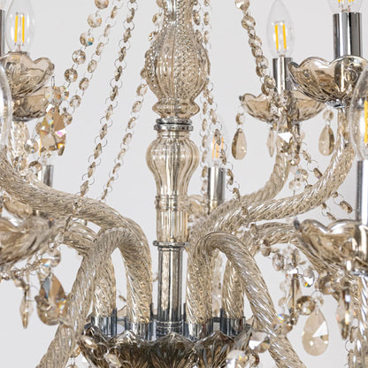 Closeup of chandelier with golden arms and crystal droplets highlighting detailed elegant luxury light design.