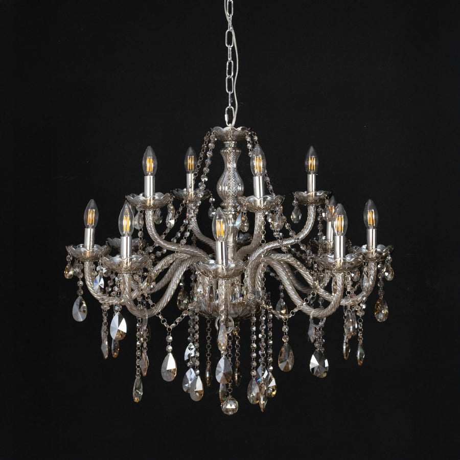 Chandelier with golden crystal detailing displayed off against black background for modern decorative style.