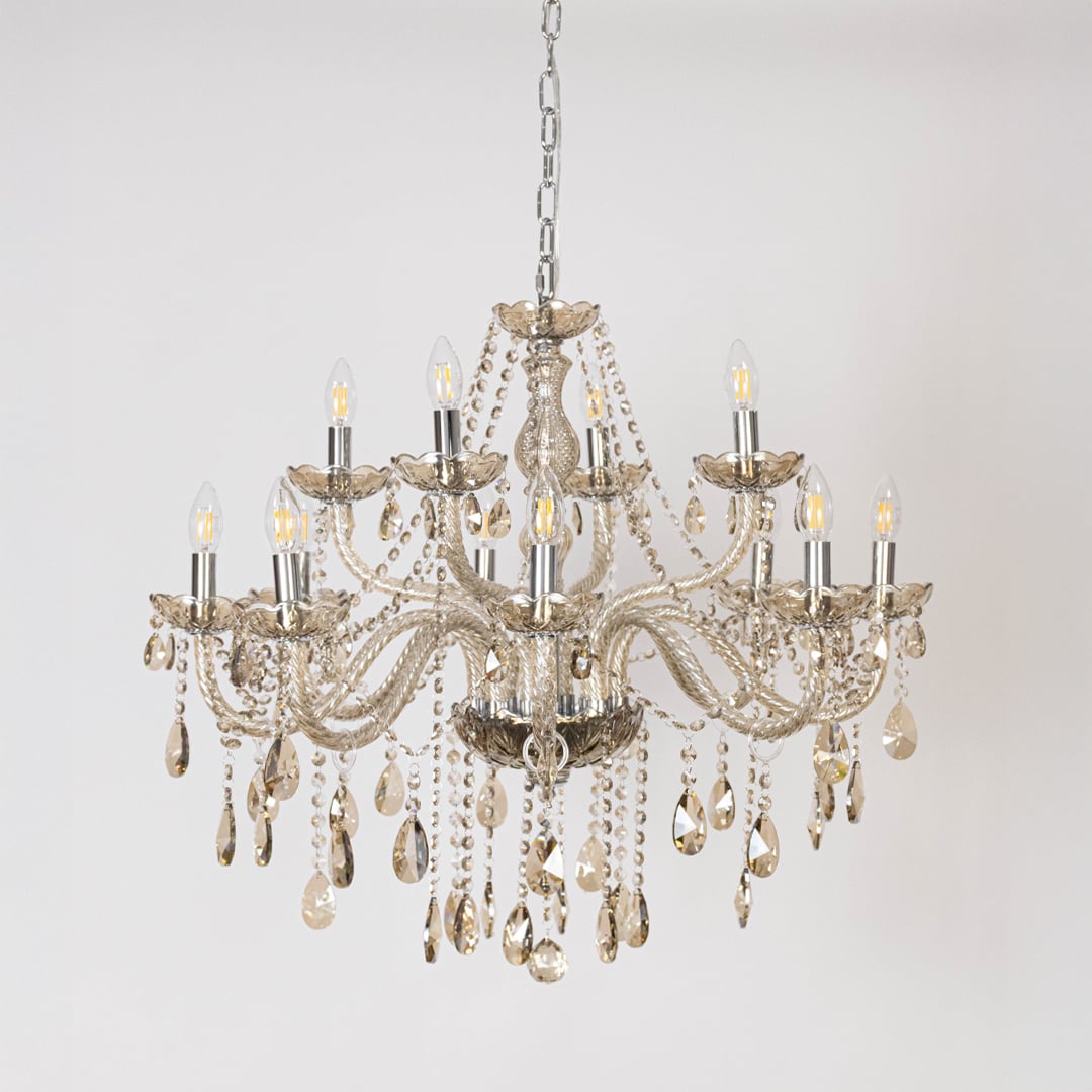 Classic chandelier with golden accents and crystal detailing displayed off on white background for luxury decor.