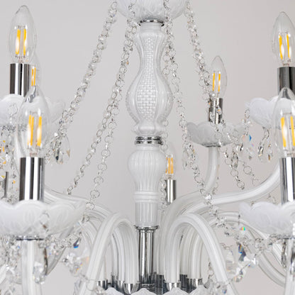 Closeup of white chandelier showing candle bulbs crystal beads and glass arms designed for luxury ceiling decor.