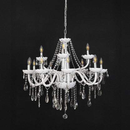 White chandelier with lights off highlighting crystal drops and glass arms against a black background.