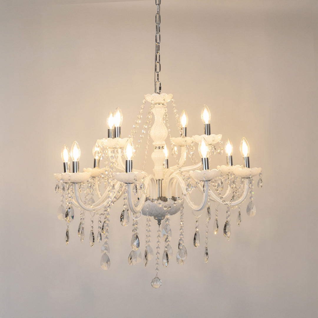 White crystal chandelier with illuminated candle bulbs and cascading crystal drops creating luxurious classic ceiling lighting.