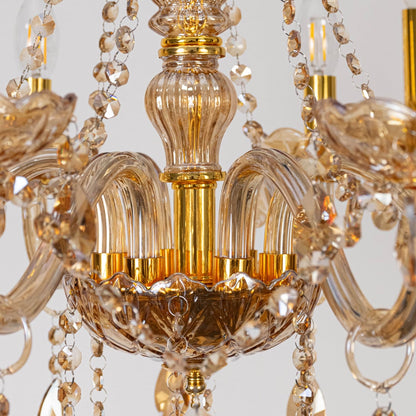 Closeup of chandelier with golden frame and crystal droplets showing elegant detailed luxury light fixture.