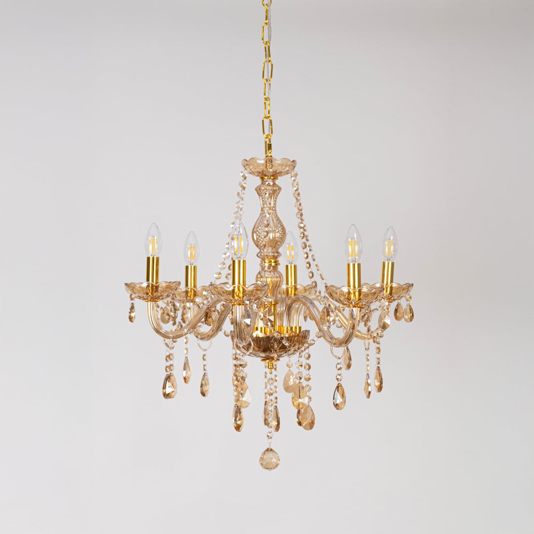 Classic golden chandelier with crystal accents displayed off on white background for decorative luxury lighting.