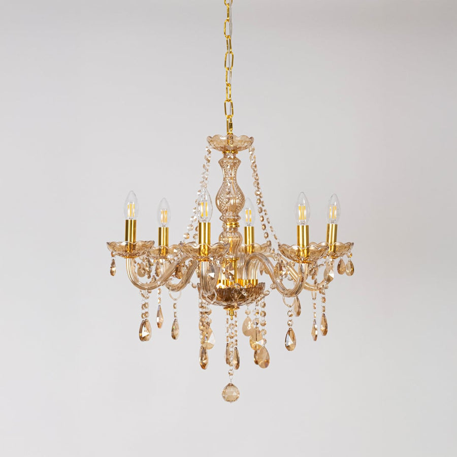 Classic golden chandelier with crystal accents displayed off on white background for decorative luxury lighting.