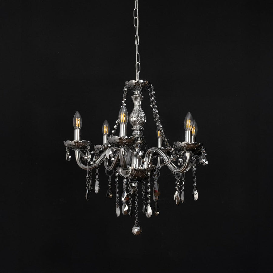 Grey chandelier with crystal accents displayed off against black background for modern luxury decorative style.
