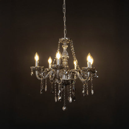 Elegant grey chandelier with crystal accents illuminated against black background for stylish interior decor.