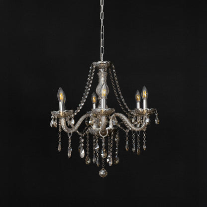 Golden chandelier with crystal detailing displayed off against black background for classic modern home style.