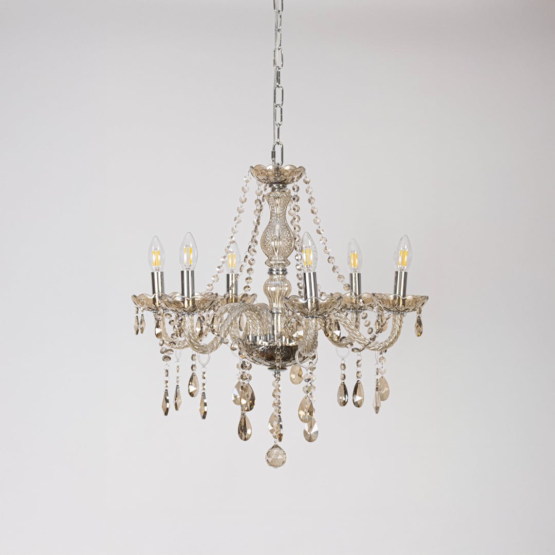 Classic golden chandelier with crystal accents displayed off on white background for stylish decorative lighting.