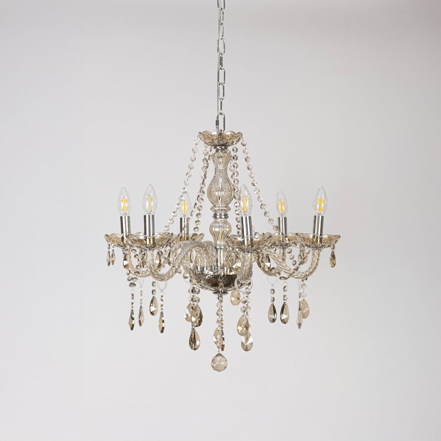Classic golden chandelier with crystal accents displayed off on white background for stylish decorative lighting.