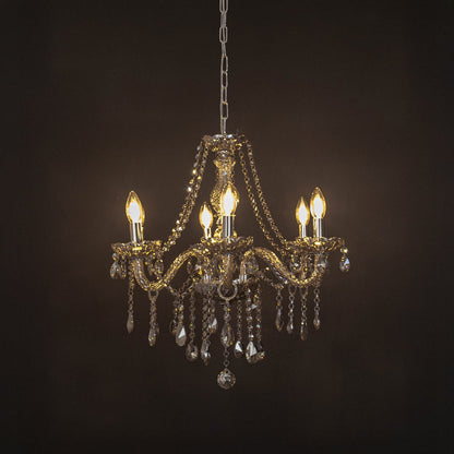 Elegant chandelier with golden crystal finish illuminated against black background for luxury home lighting.