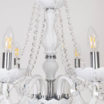 Closeup of white chandelier with crystal detailing showing elegant design with hanging droplets for home decor