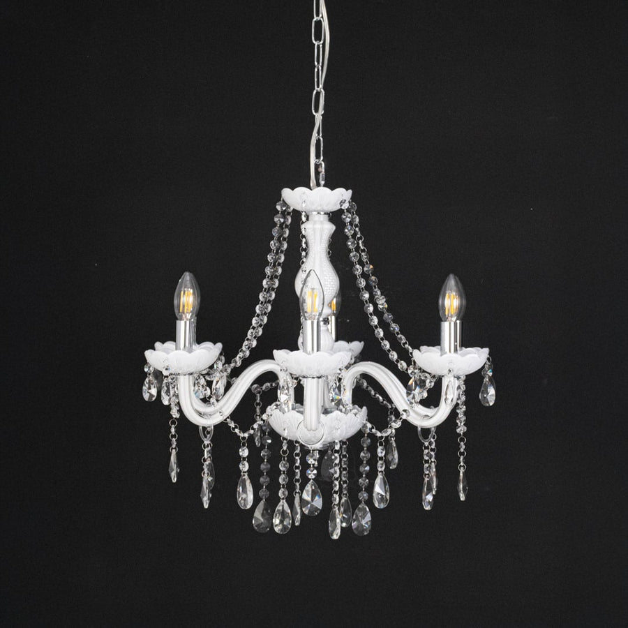 White chandelier with crystal droplets displayed off against black background for stylish luxury decorative style.