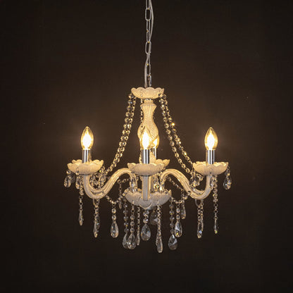 Elegant white chandelier with crystal accents illuminated against black background for modern decorative lighting.