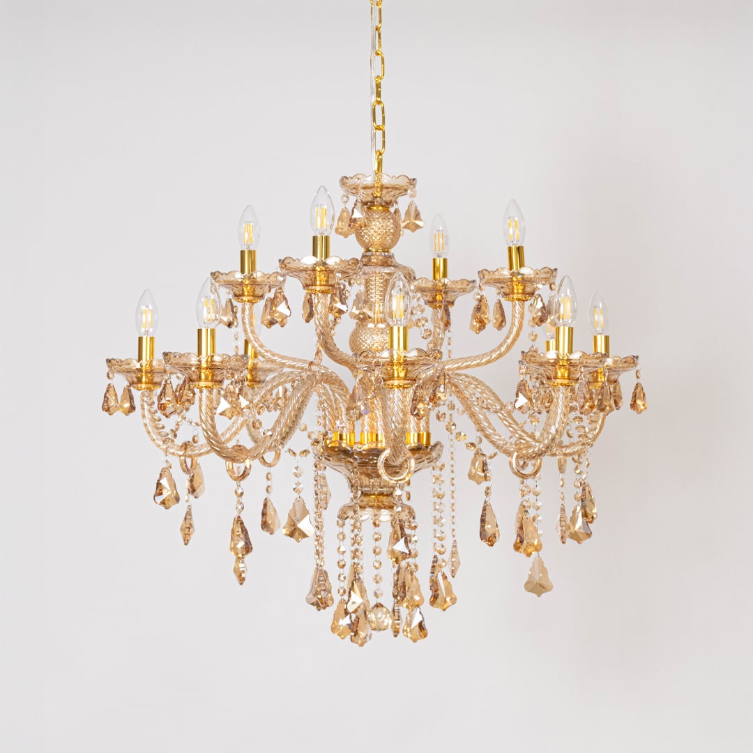 Golden chandelier with lights off featuring crystal beads and decorative glass arms on plain white background.