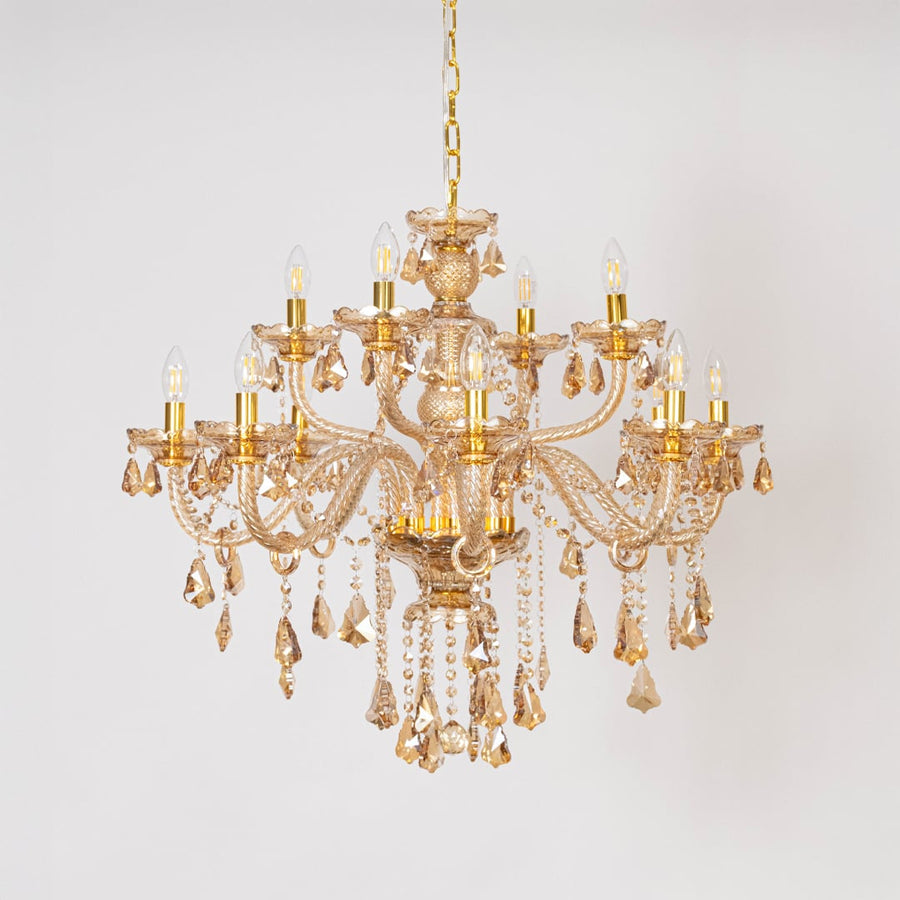 Golden chandelier with lights off featuring crystal beads and decorative glass arms on plain white background.