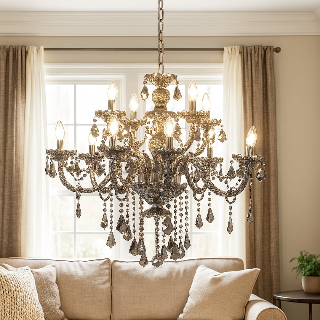 Black chandelier with crystal accents glowing warmly above a sofa and wall art in a cozy living room space.