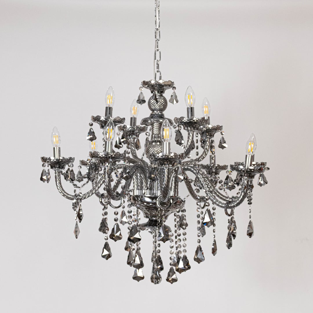 Black chandelier with lights off showing decorative arms and crystal chains on plain white background.