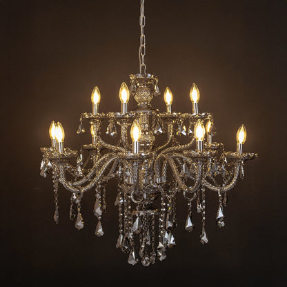 Black chandelier with lights on glowing warmly with crystal drops and glass arms against a black background.