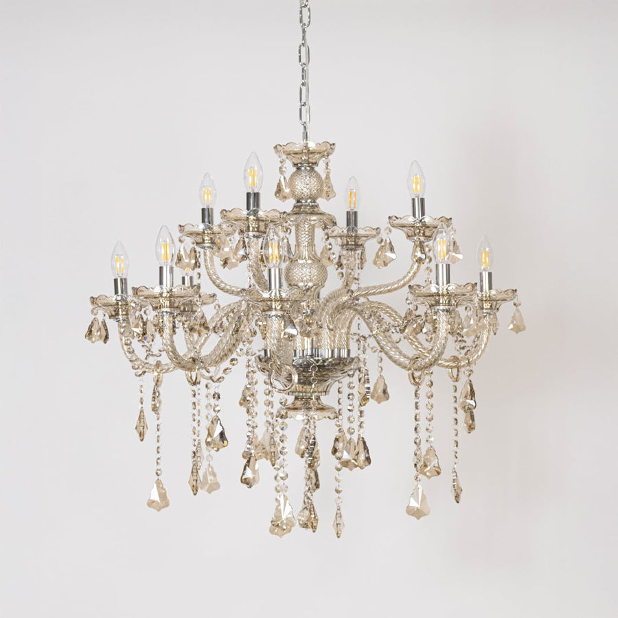 Chandelier with lights off showing crystal hanging design and detailed glass body on plain white background.