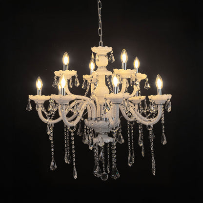 White chandelier with lights on glowing warmly with crystal drops and glass body against a black background.